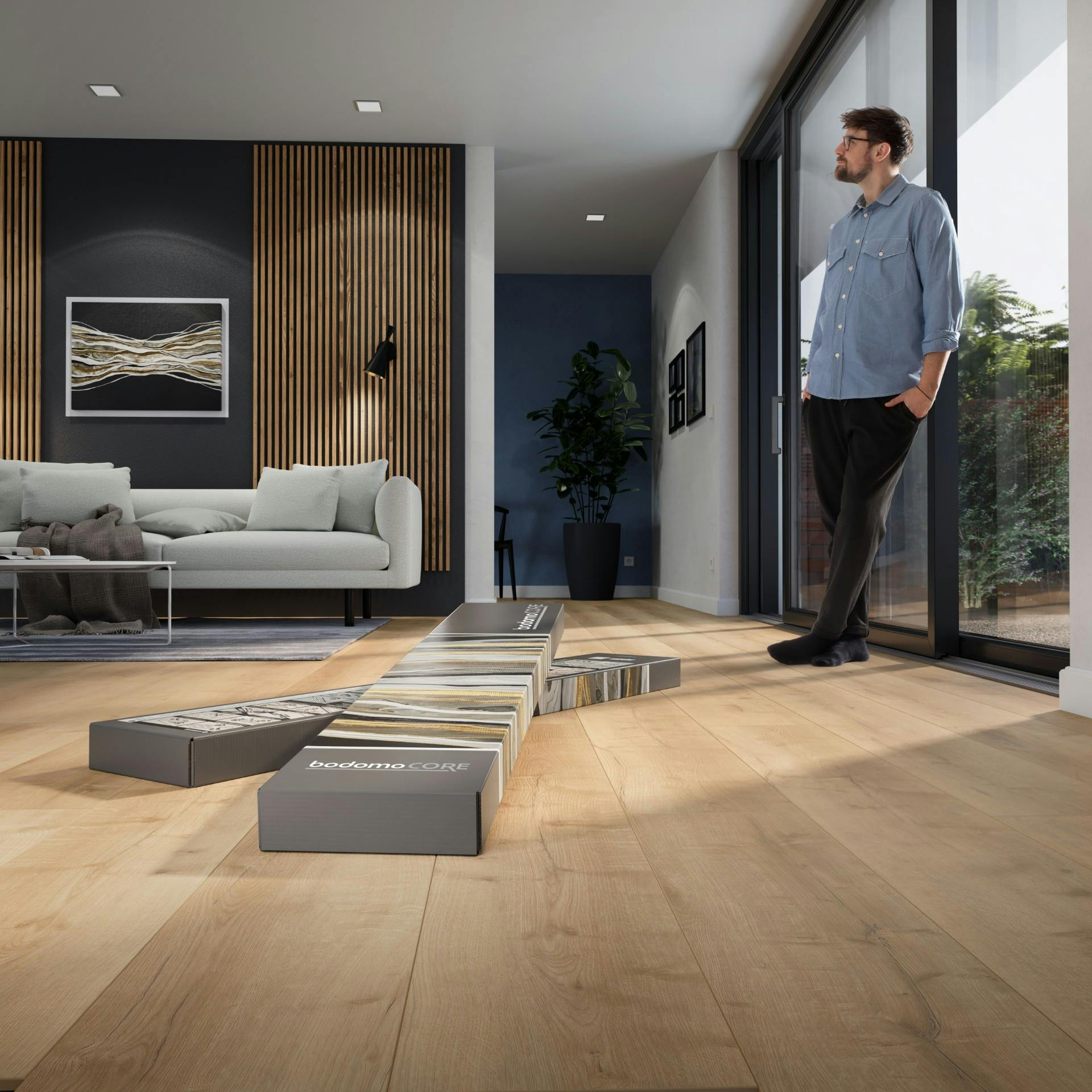 Mann im Wohnzimmer mit bodomoCORE Vinylboden